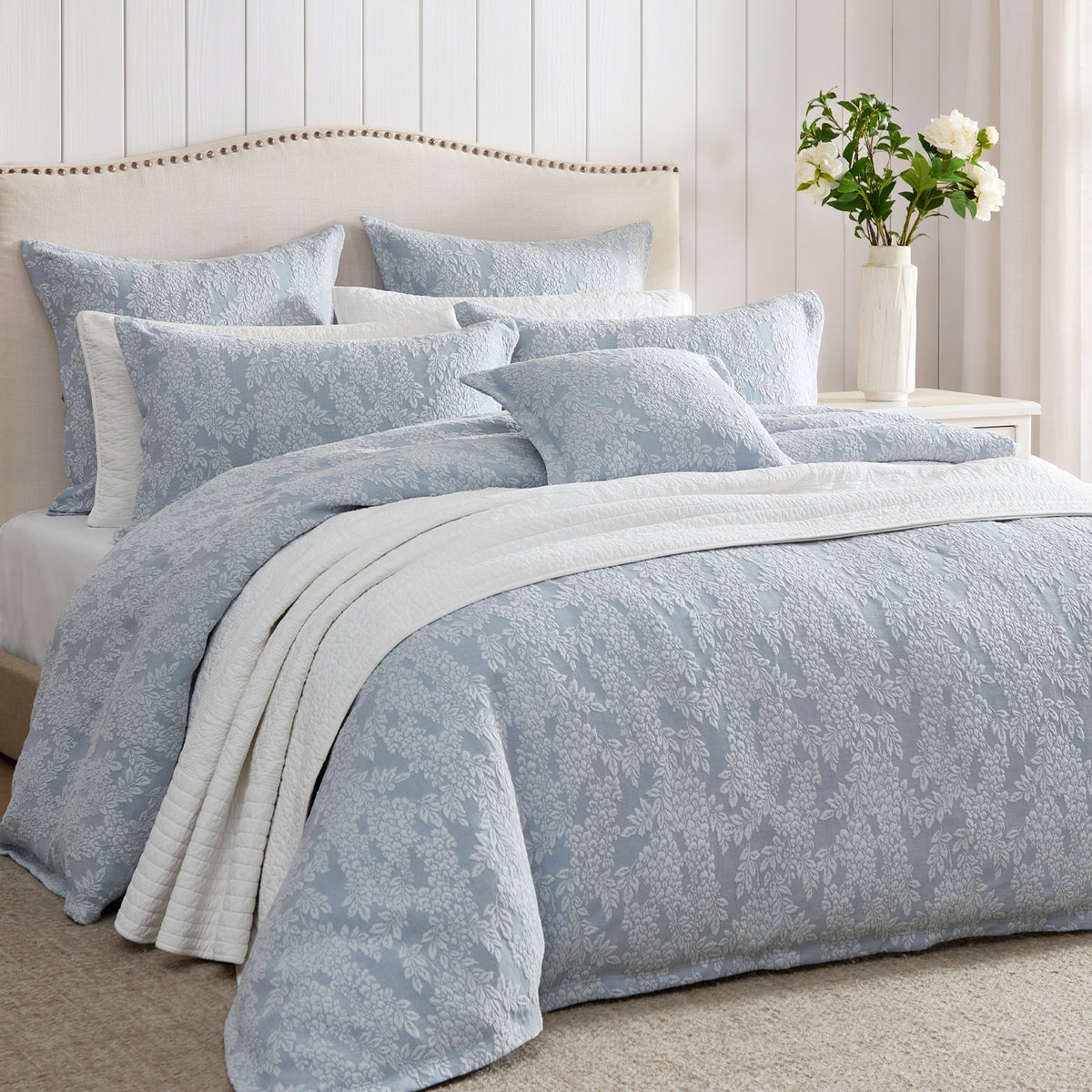 Private Collection Garden Veil Duvet Cover Set in Chambray styled with matching floral pillowcases, a white quilted throw and layered cushions in a classic bedroom.