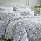 Private Collection Hydrangea Duvet Cover Set styled on a bed with matching floral pillowcases, white quilted bedding and a soft grey botanical design.