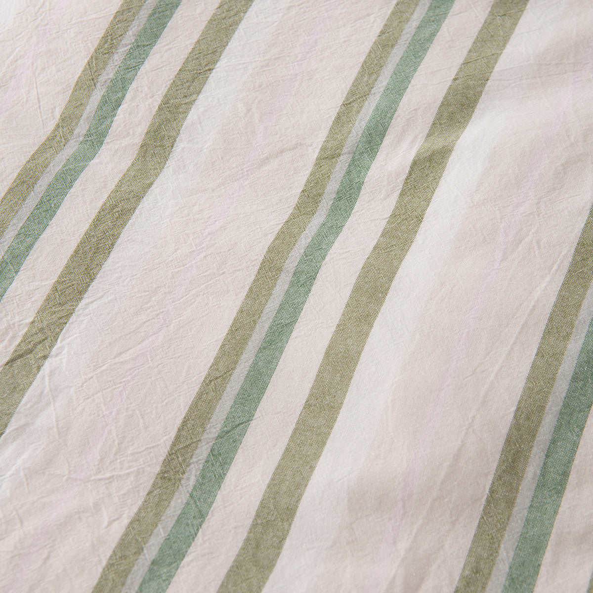 Close-up of the Marlo Neve Cotton Duvet Cover Set, showing the soft green striped pattern and lightly textured cotton fabric.