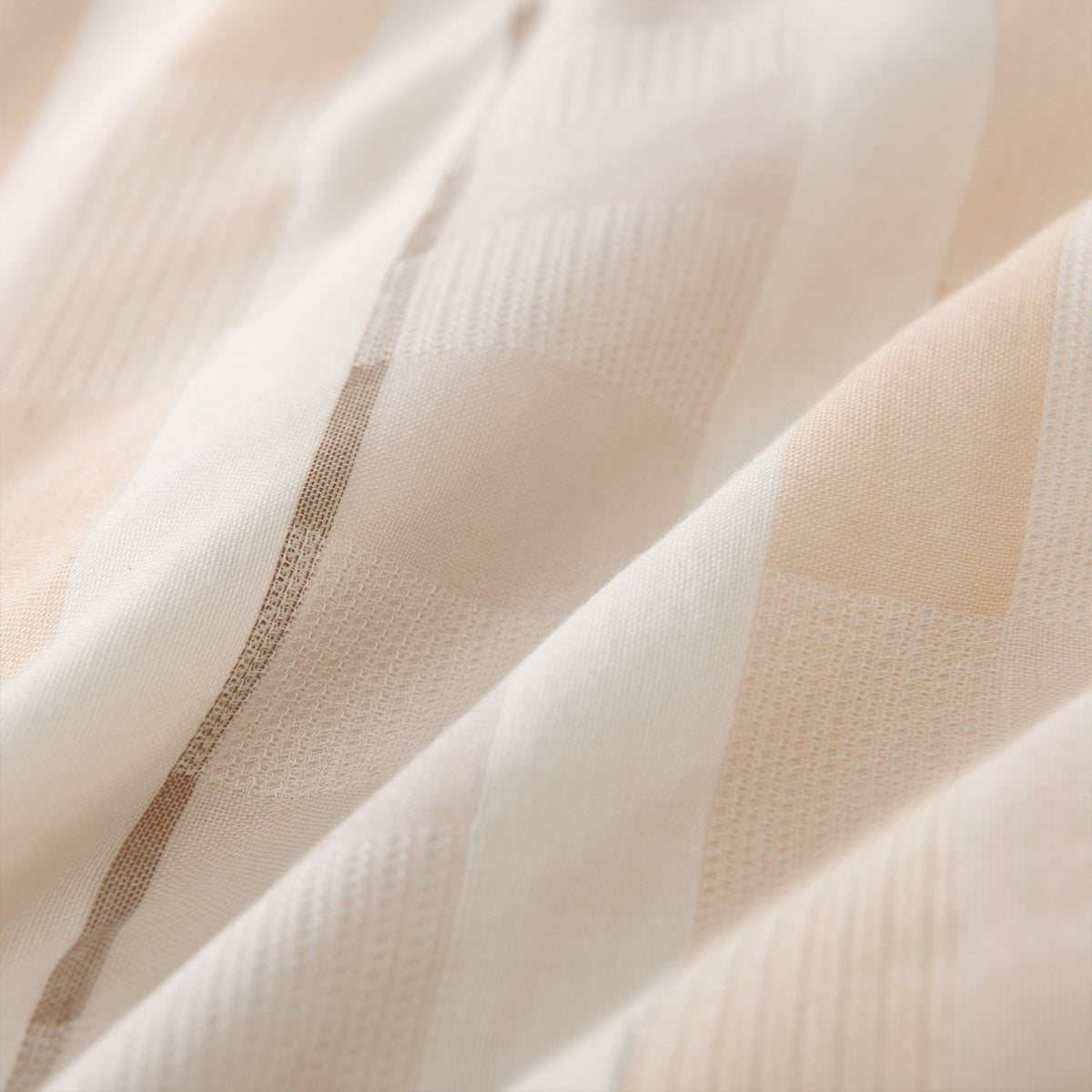 Close-up of a matching pillowcase featuring the cream, beige and grey striped jacquard design.