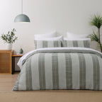 Baker St. Linen Calvin Cotton Jacquard Duvet Cover Set in Multi Coloured, styled on a bed with matching pillowcases, featuring wide grey and white textured vertical stripes.