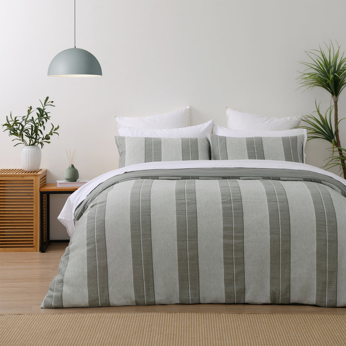 Baker St. Linen Calvin Cotton Jacquard Duvet Cover Set in Multi Coloured, styled on a bed with matching pillowcases, featuring wide grey and white textured vertical stripes.