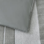 Close-up of the Baker St. Linen Calvin Cotton Jacquard Duvet Cover Set, showing the smooth grey reverse fabric alongside the textured striped front.