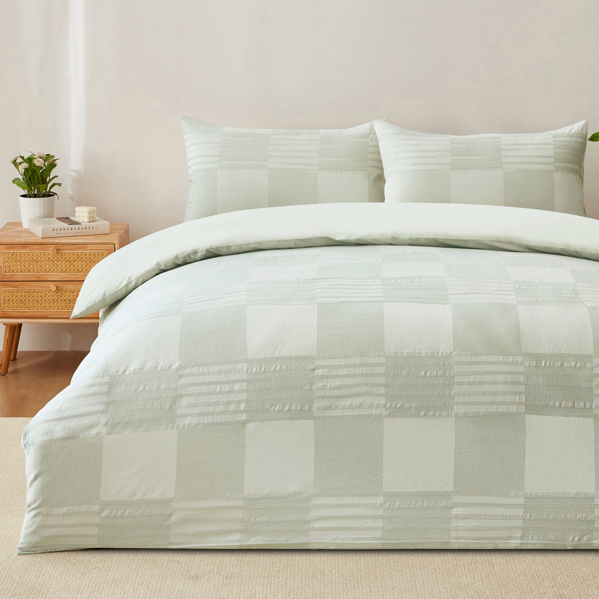 Baker St. Linen Zane Cotton Jacquard Duvet Cover Set in Sage styled on a bed with matching pillowcases, showcasing its soft green check design and textured detailing.