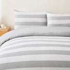 Baker St. Linen Samson Cotton Jacquard Duvet Cover Set in Grey styled on a bed with matching pillowcases, highlighting its grey and white striped design.