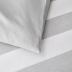 Baker St. Linen Samson Cotton Jacquard Duvet Cover Set in Grey styled on a bed with matching pillowcases, highlighting its grey and white striped design.