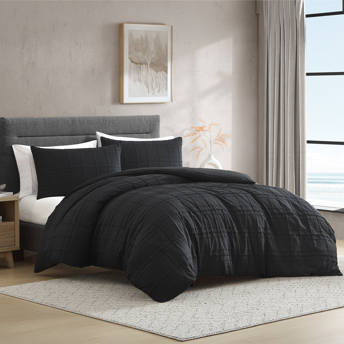 Ebony: A bed styled with the Solace Barker Textured Duvet Cover Set in ebony, featuring a raised check pattern and matching pillowcases in a modern neutral bedroom.