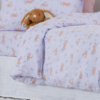 Purple animal print kids duvet cover styled on a bed with matching pillowcase.
