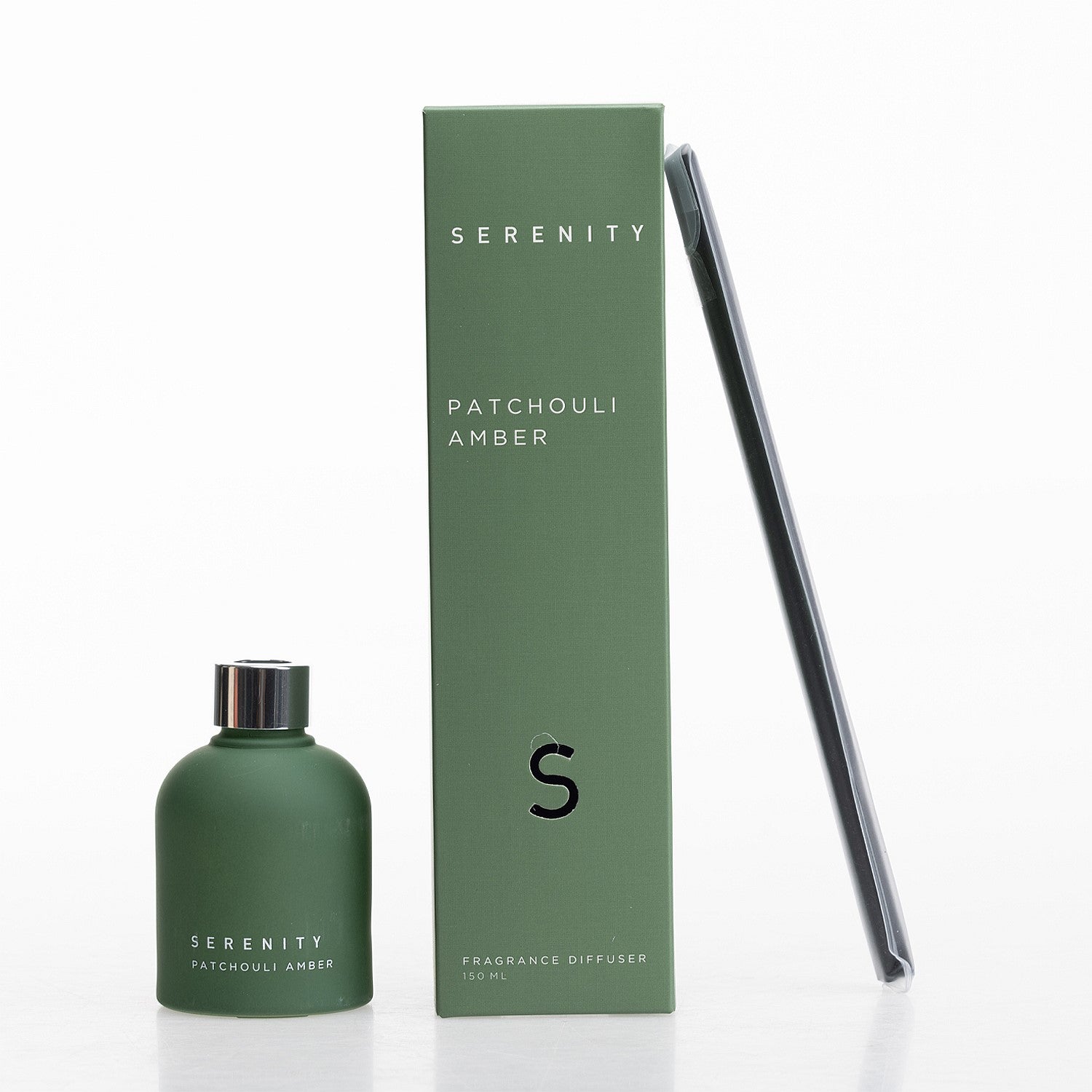 Serenity Patchouli Amber diffuser with frosted green bottle, matching box, and reed sticks.