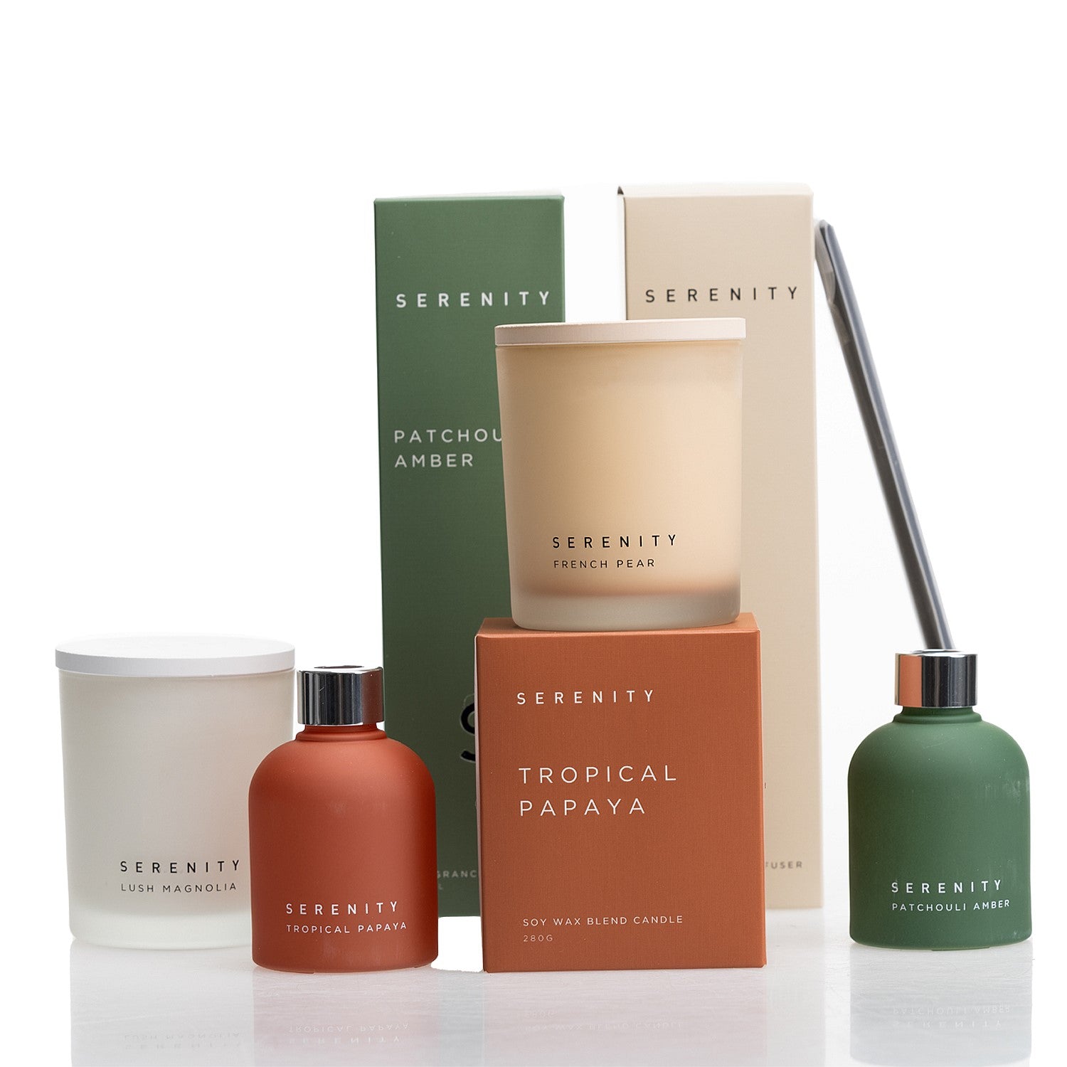 Serenity frosted diffuser and candle range group shot featuring Tropical Papaya, French Pear, Lush Magnolia, and Patchouli Amber.