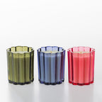 The Aromatherapy Co. Petal candles in green, blue and pink fluted glass vessels.