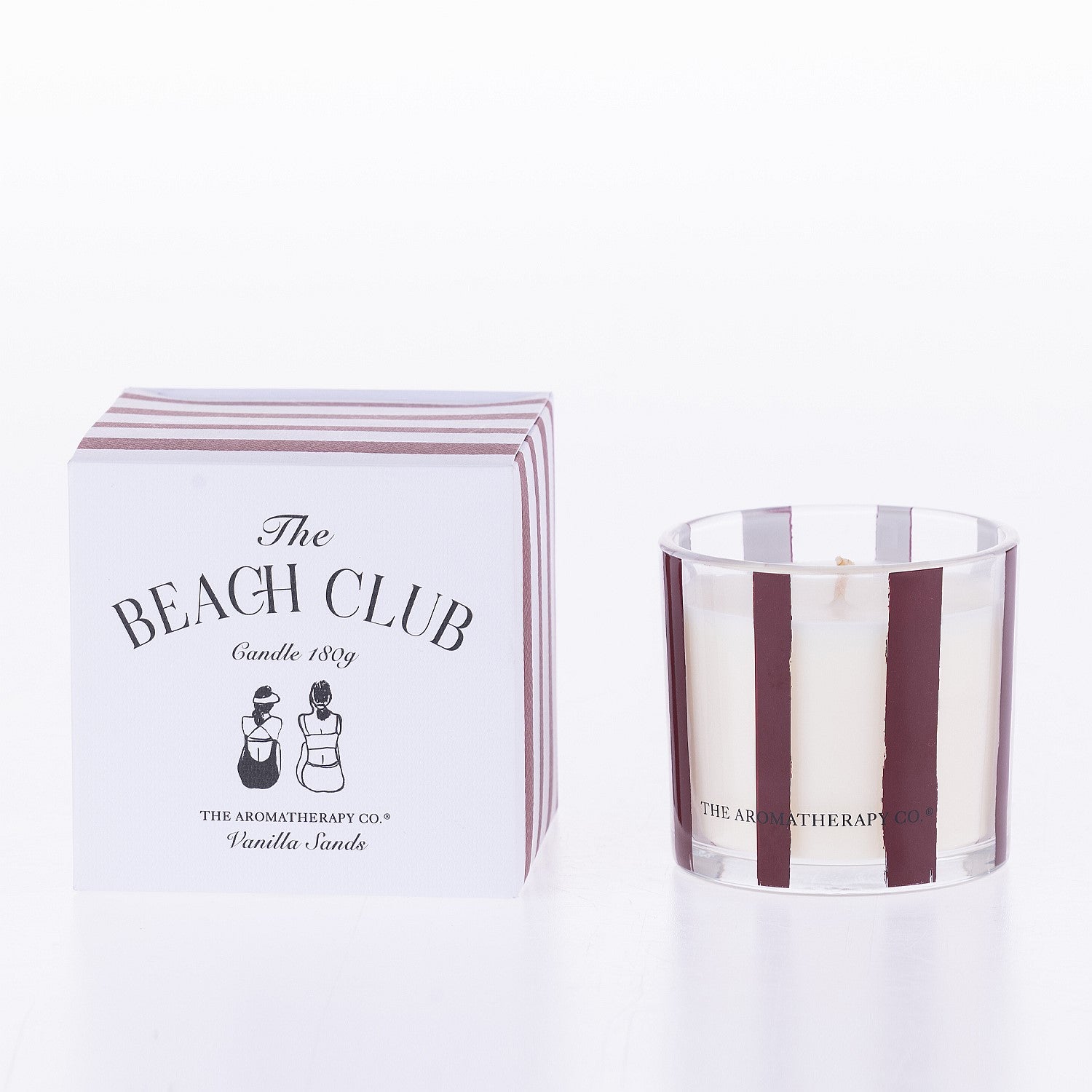 The Aromatherapy Co. The Beach Club vanilla sands 180g candle with matching striped box on a white background.