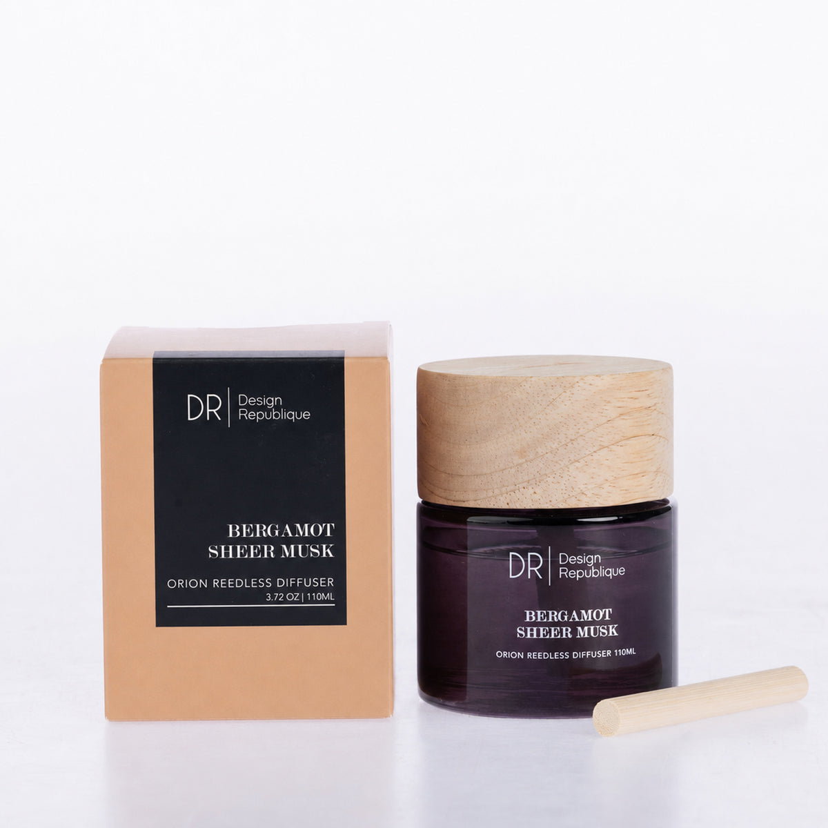 Design Republique Orion Reedless Diffuser in Bergamot Sheer Musk, featuring a dark purple glass vessel, natural wood-look lid and bamboo diffuser insert, shown with coordinating packaging.