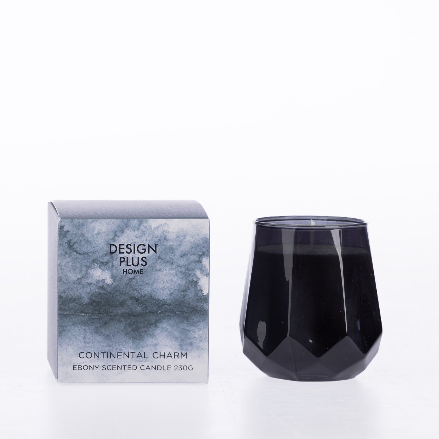 Design Plus Home Continental Charm Ebony Scented Candle 230g in a dark smoky faceted glass vessel, displayed beside its grey-blue packaging.