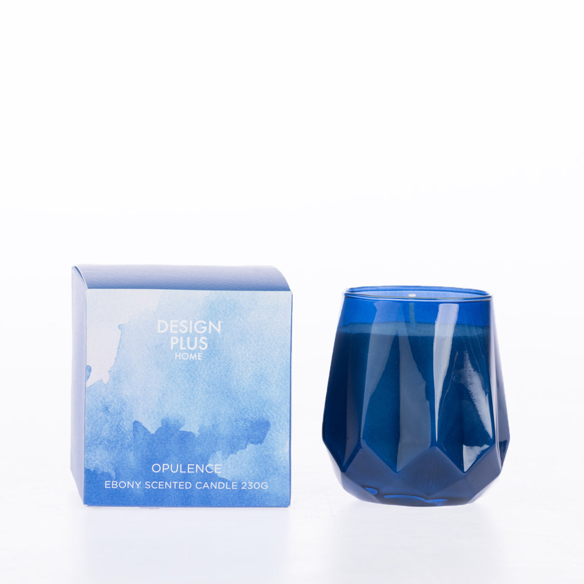 Design Plus Home Opulence Ebony Scented Candle 230g in a deep blue faceted glass vessel, displayed beside its blue packaging.