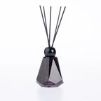 Design Plus Home Berry Ebony Diffuser 180ml in a dark purple faceted glass vessel with black reed sticks and a glossy black cap.