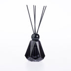 Design Plus Home Continental Charm Ebony Diffuser 180ml in a smoky black faceted glass vessel with black reed sticks and a glossy black cap.