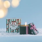 Christmas Wishes Bow Candle in a Box 110g Peach & Kiwi Punch – Green ribbed scented soy candle with pink ribbon detailing and a bow-topped lid, displayed beside its coordinating green and white striped Peach & Kiwi Punch gift box.