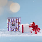 Christmas Wishes Bow Candle in a Box 110g Crimson Berry – White ribbed scented soy candle with red detailing and a clear bow-topped lid, displayed beside its purple and white striped Crimson Berry gift box.