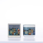 Design Republique Ines Orchid Fresh 200g scented candle featuring colourful buildings against a dusky blue background with matching packaging.