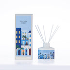 Design Republique Ines Lychee Berry 180ml reed diffuser with white reeds, blue illustrated buildings and coordinating packaging.