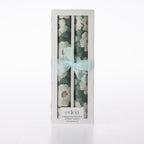 Eden Magnolia Scented Drawer Liners 8 Pack featuring two rolls of dark green floral liners with large white magnolia flowers, presented in a white window box with a pale blue ribbon bow.