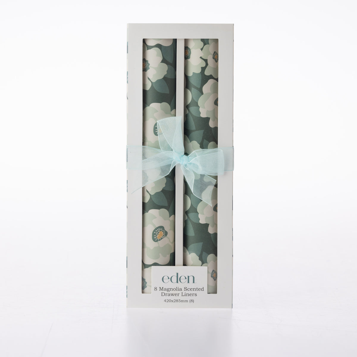 Eden Magnolia Scented Drawer Liners 8 Pack featuring two rolls of dark green floral liners with large white magnolia flowers, presented in a white window box with a pale blue ribbon bow.