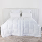 Solace Duo Comfort Duvet Inner out displayed on a bed with white pillows 