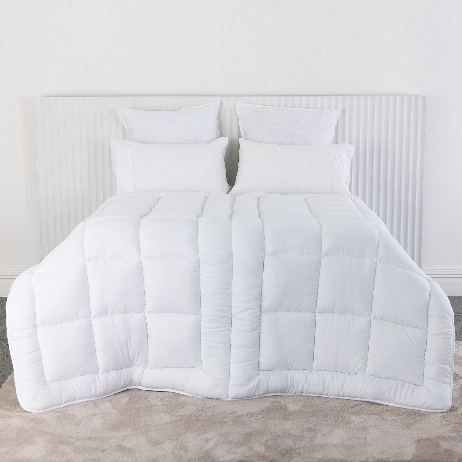 Solace Duo Comfort Duvet Inner out displayed on a bed with white pillows 