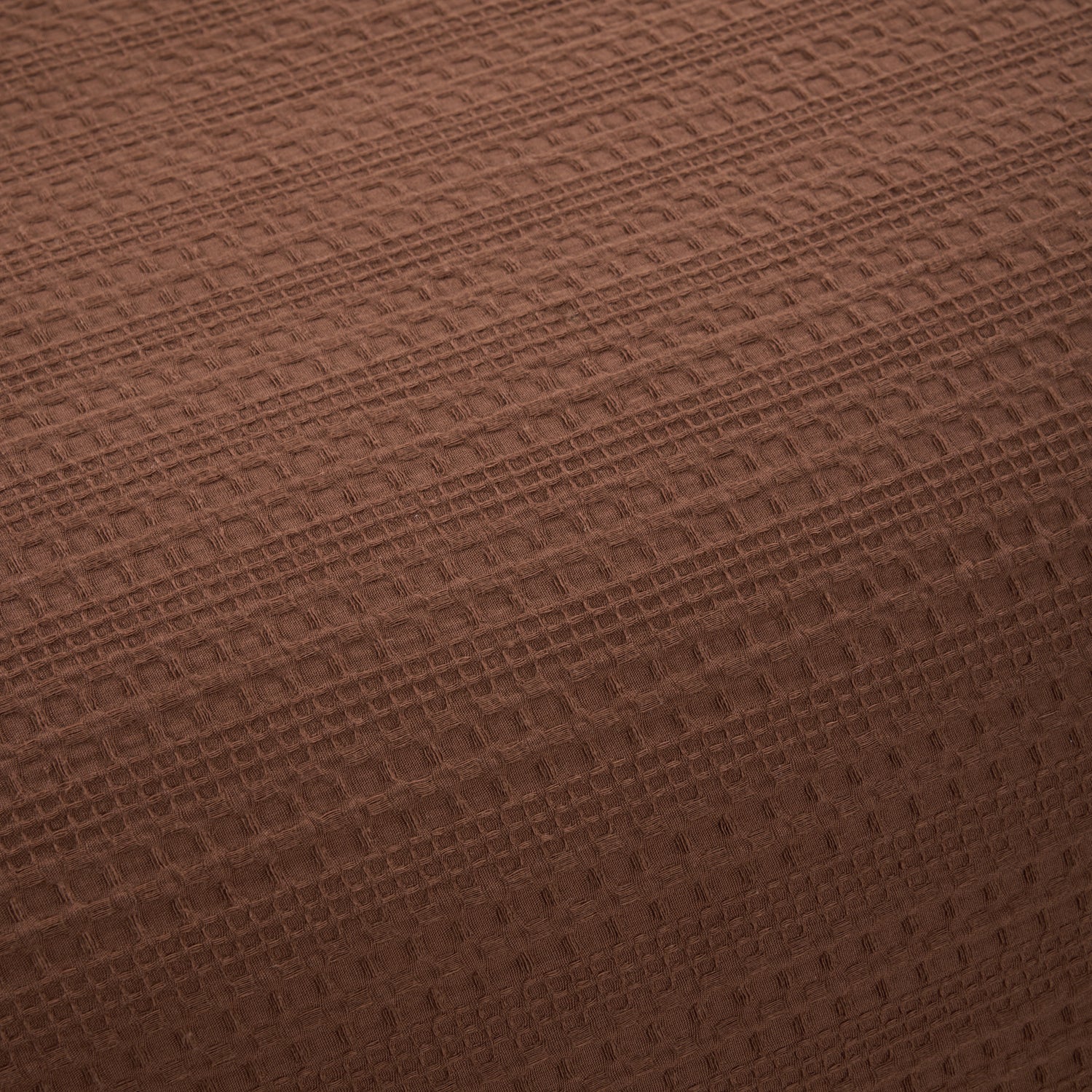 Close-up of the Design Plus August Cotton Waffle Duvet Cover Set in brick, showcasing the textured waffle weave fabric and rich red brick colour.
