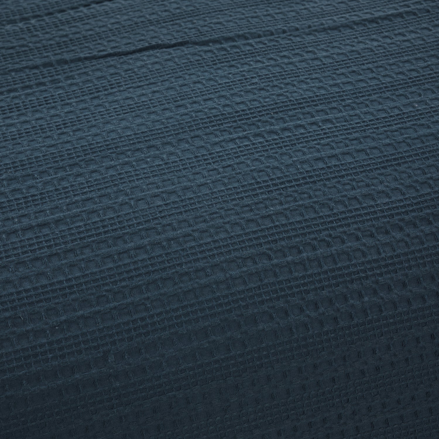 Close-up of the Design Plus August Cotton Waffle Duvet Cover Set in Diesel Blue, showcasing the textured waffle weave fabric and Diesel blue colour.