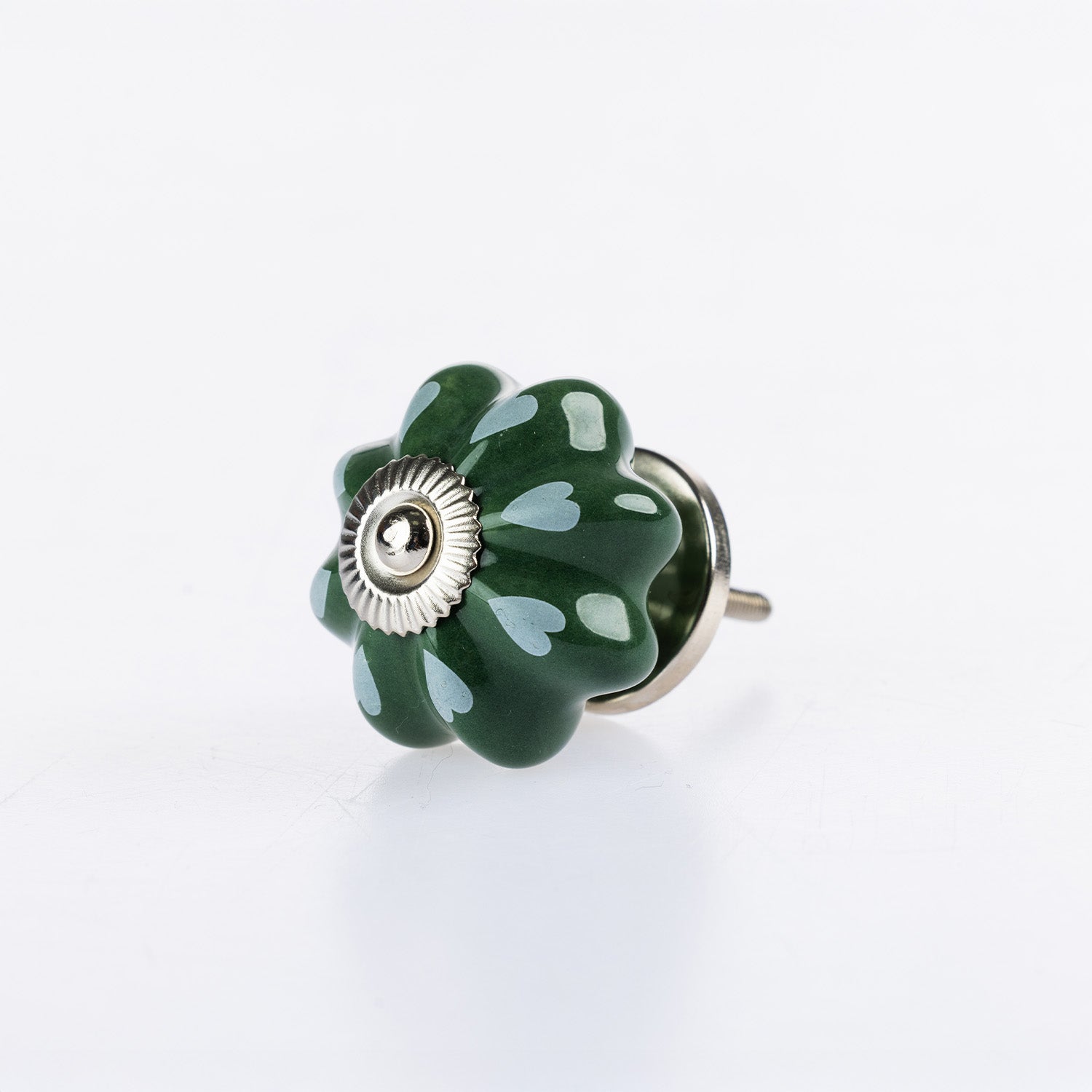 Green & White flower-shaped ceramic drawer knob with white heart pattern detailing and silver metal centre accent.