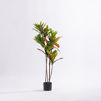 Artificial 115cm codiaeum tree with vibrant green, yellow, orange and red variegated foliage displayed in a black nursery pot.