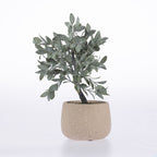 An artificial olive tree with textured green-gray leaves in a speckled beige ceramic pot, set against a plain white background.