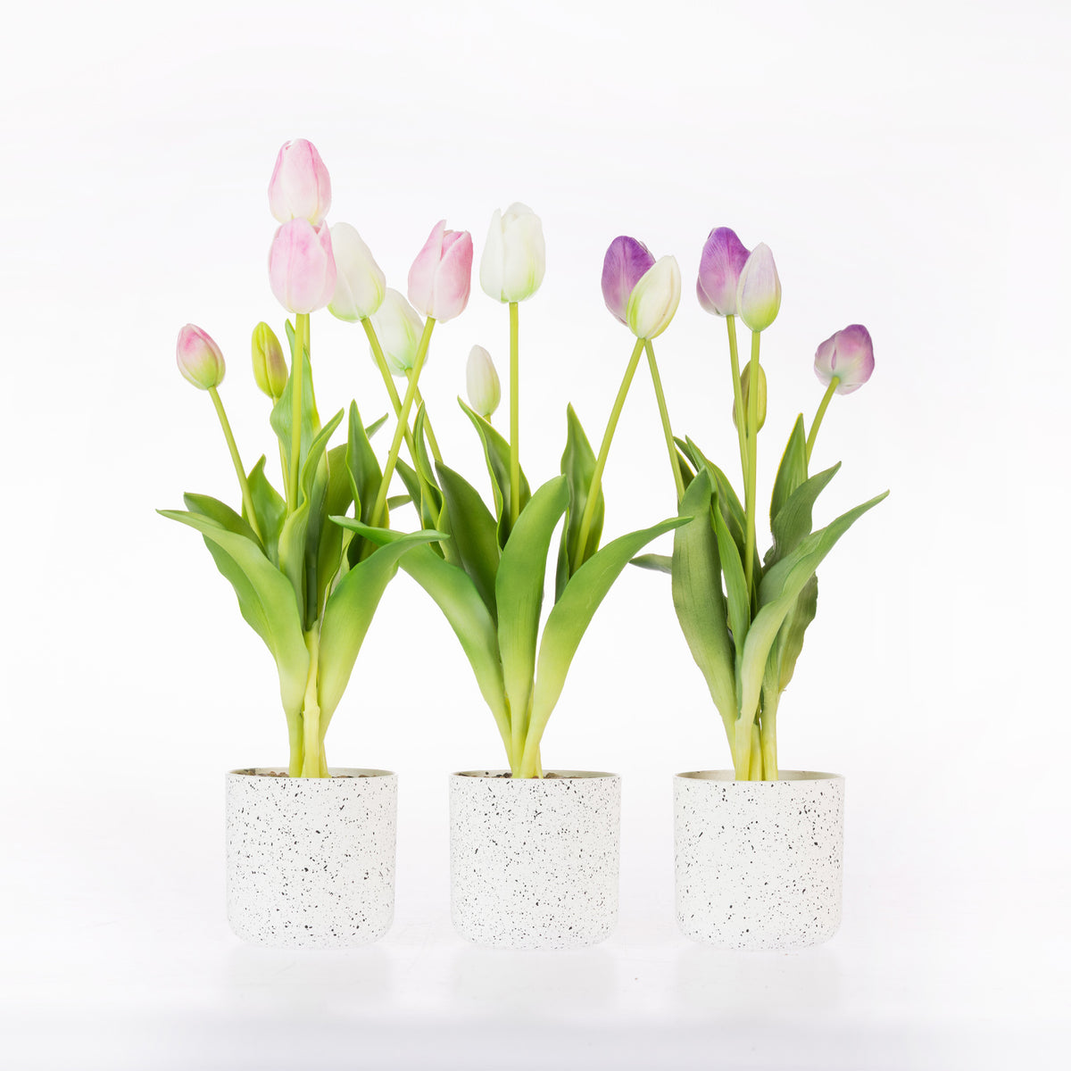 Three artificial tulip planters with pink, white, and purple tulips in white speckled pots, set against a plain white background.