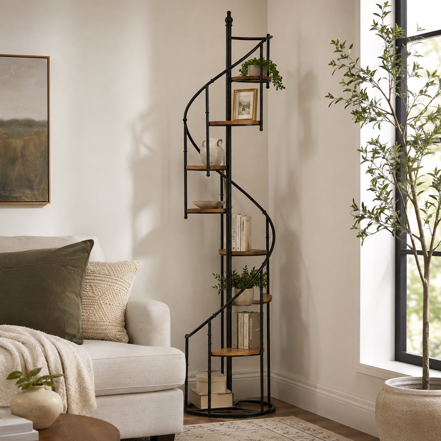 Black spiral display shelf styled in a living room corner with books, framed artwork, decorative vases, plants, and a cream sofa.