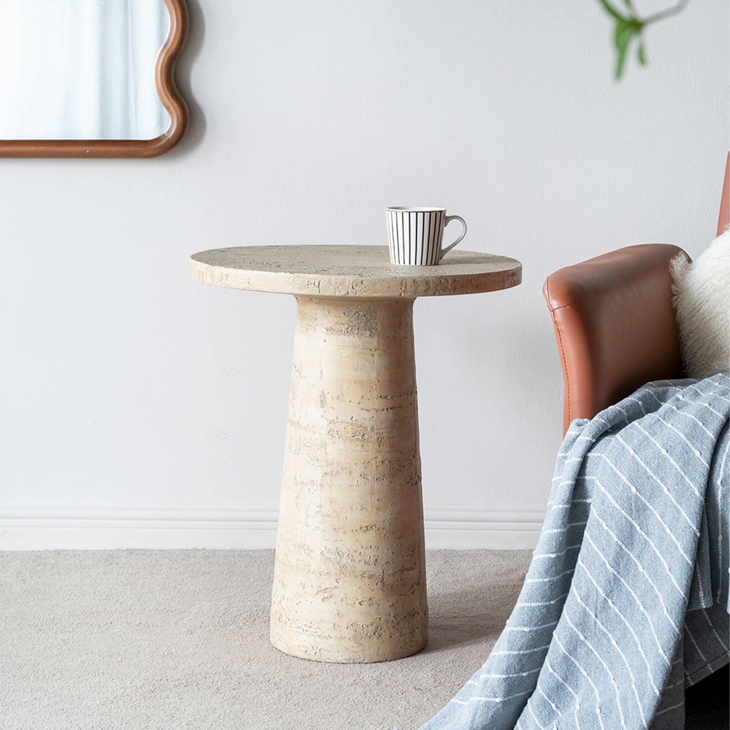 Design Republique Natural Cement Round Side Table in a room setting.