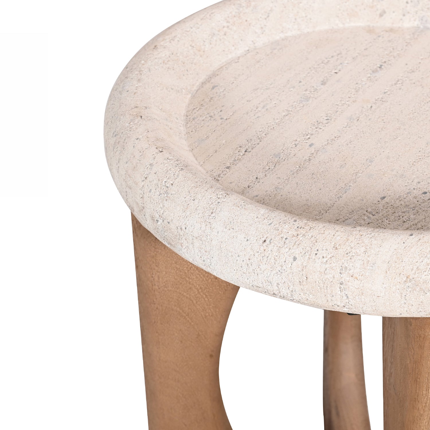 Close-up of the Amparo Fleur stone side table showing the rounded textured stone top and curved wooden base.