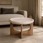 Amparo Fleur stone coffee table styled in a warm neutral living room with a textured sofa and rug.