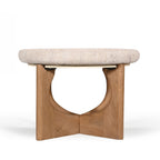 Amparo Fleur stone coffee table shown from the front with a thick rounded stone top and curved wooden base.