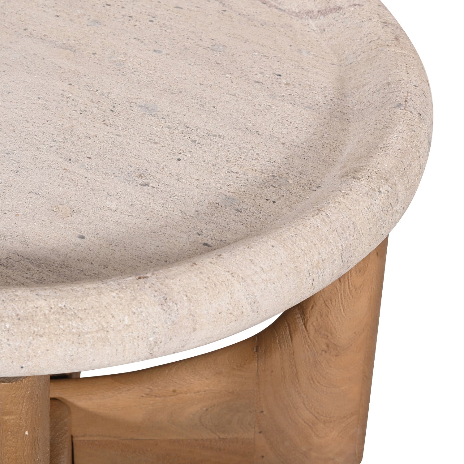 Close-up of the Amparo Fleur stone coffee table showing the textured stone top and natural wood base detail.