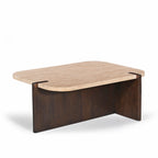 Three-quarter view of the Carter Marble Coffee Table on a white background, featuring a rounded rectangular marble top with softly curved corners and a bold dark timber pedestal base.