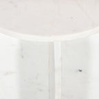 Close-up of the white marble tabletop and intersecting pedestal base, showcasing the natural veining and polished finish.