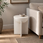 Amparo mango wood side table in a realistic living room setting beside a neutral sofa, styled with a small bowl on top.
