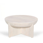 Amparo mango wood coffee table in white wood shown against a plain white background, highlighting the round tabletop and curved base design.