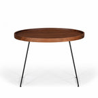 Side view of large Amparo Acacia coffee table showing slim black iron legs and wooden top.