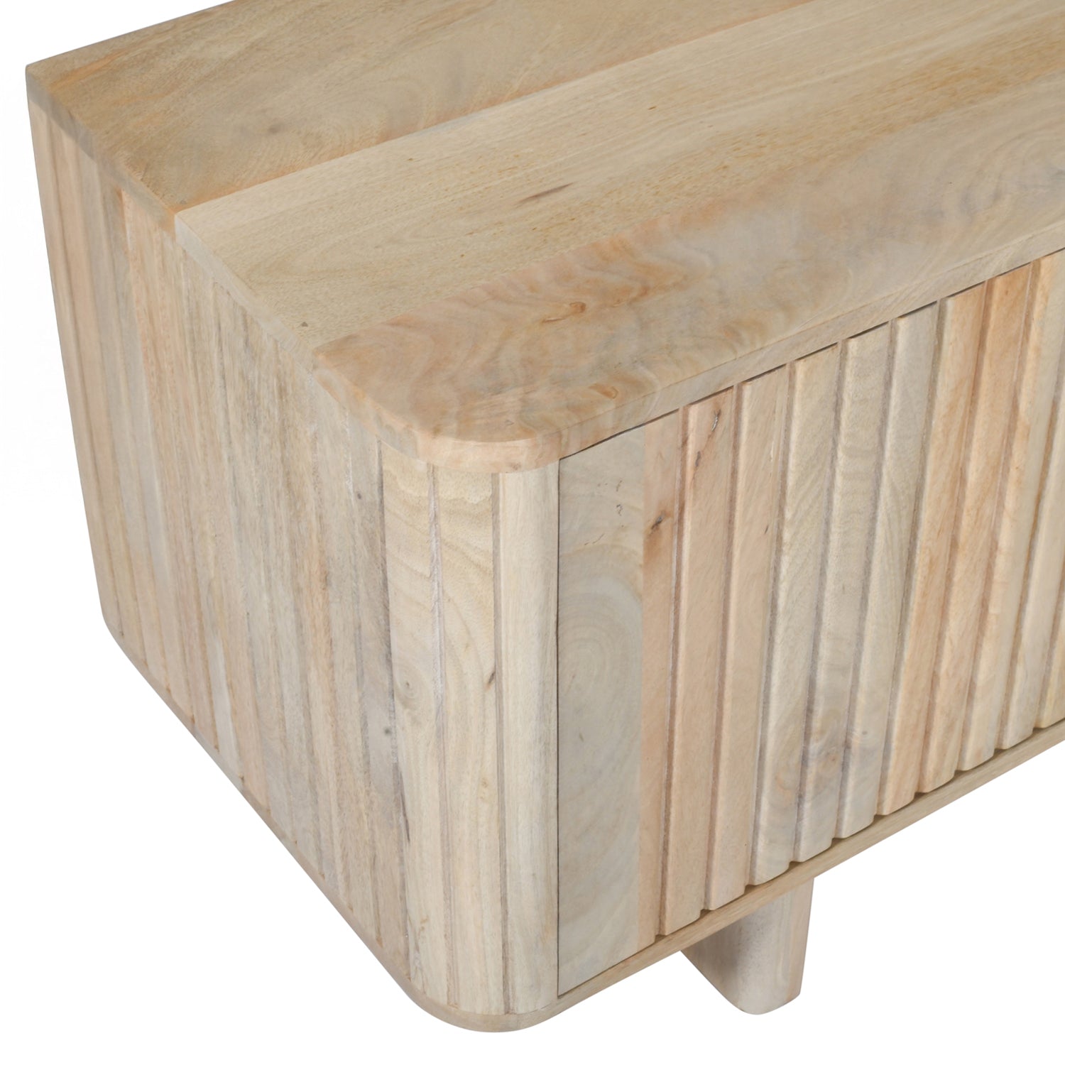 Close-up of the rounded corner and vertical slatted detailing on the natural mango wood entertainment unit.