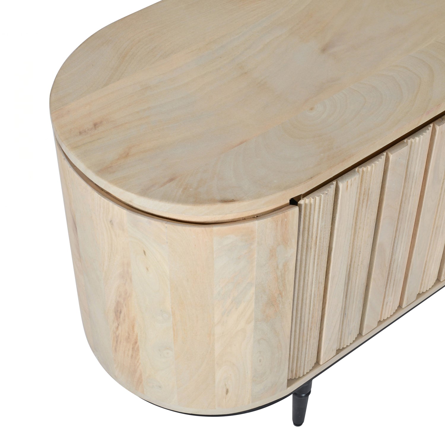 Close-up of the rounded corner, smooth mango wood top, and fluted sliding door detailing of the entertainment unit.