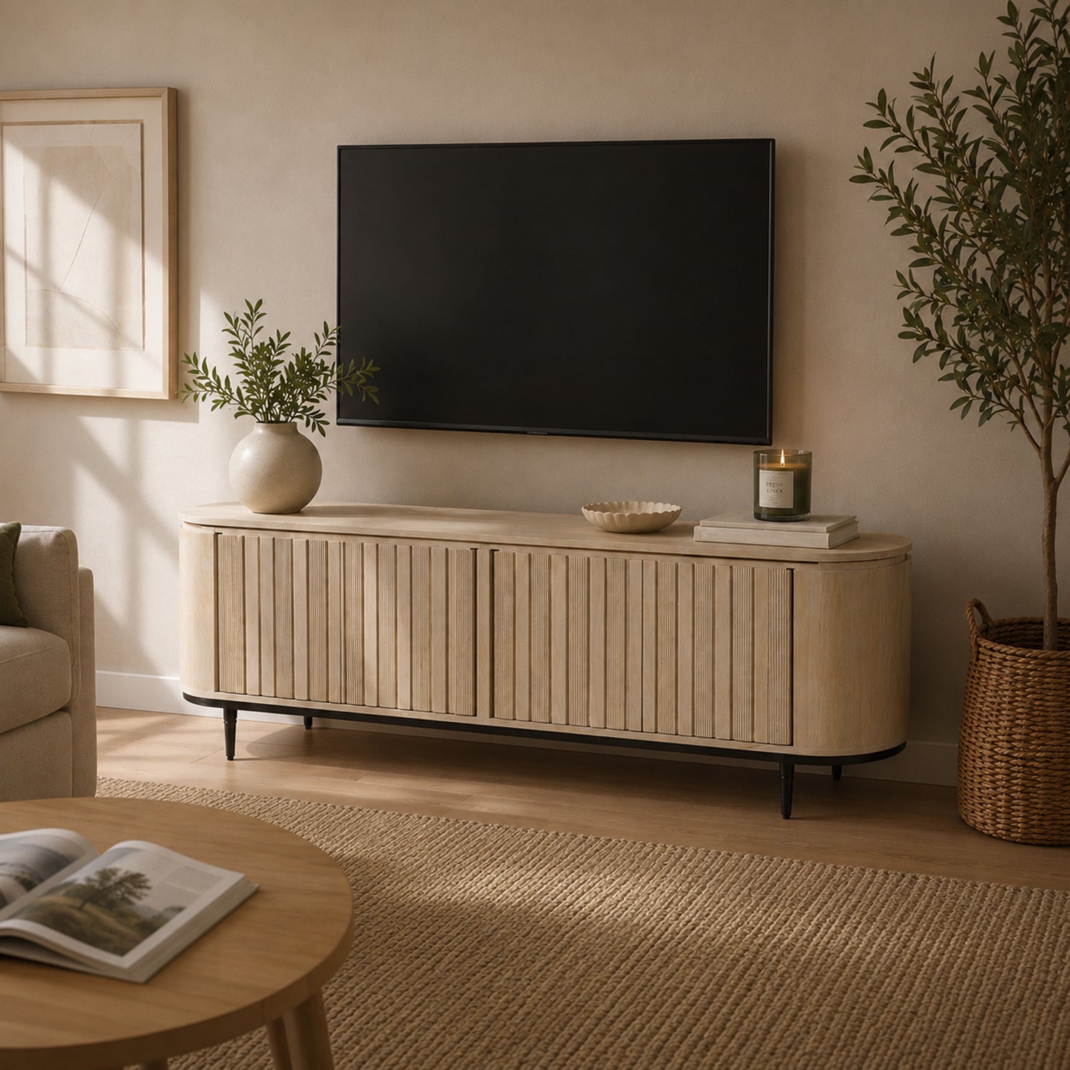 Angled view of the natural mango wood entertainment unit showcasing the fluted sliding doors, rounded profile, and black metal legs.