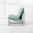 The side view of a two-seat cushioned outdoor sofa with a slim green metal frame and green cushions, set against a clean white background.
